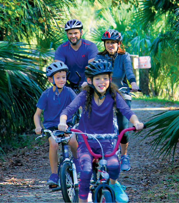 A family cycling along a park trail