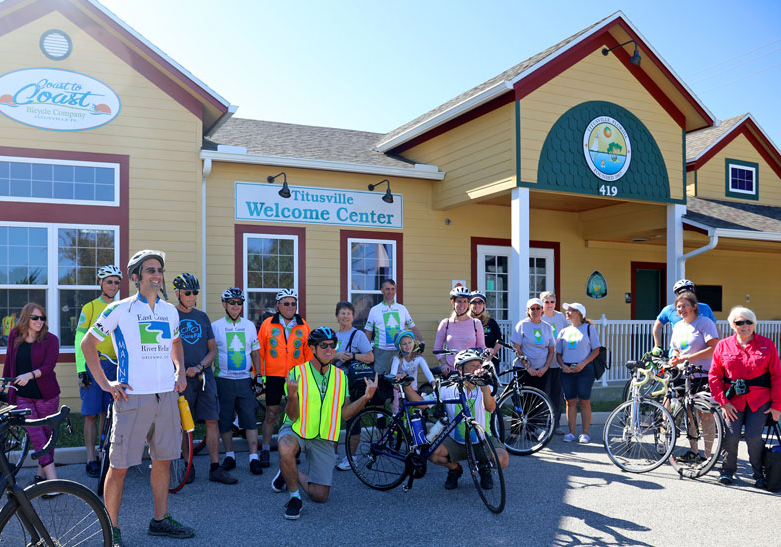 Greenway-Ride-WelcomeCenter Bike riders from the East Coast Greenway Tour pose outside of Titusville's downtown Welcome Center on November 17, 2018.