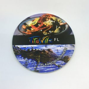 Launch From Here coaster featuring a cooked crab and an aligator in the water