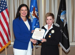  Performing the Duties of Undersecretary of the Air Force Kristyn Jones (left) presents the Distinguished Public Service Award to Lynda Weatherman (right) during an award ceremony, Joint Base Andrews, Md. (Air Force Photo by Andy Morataya) 